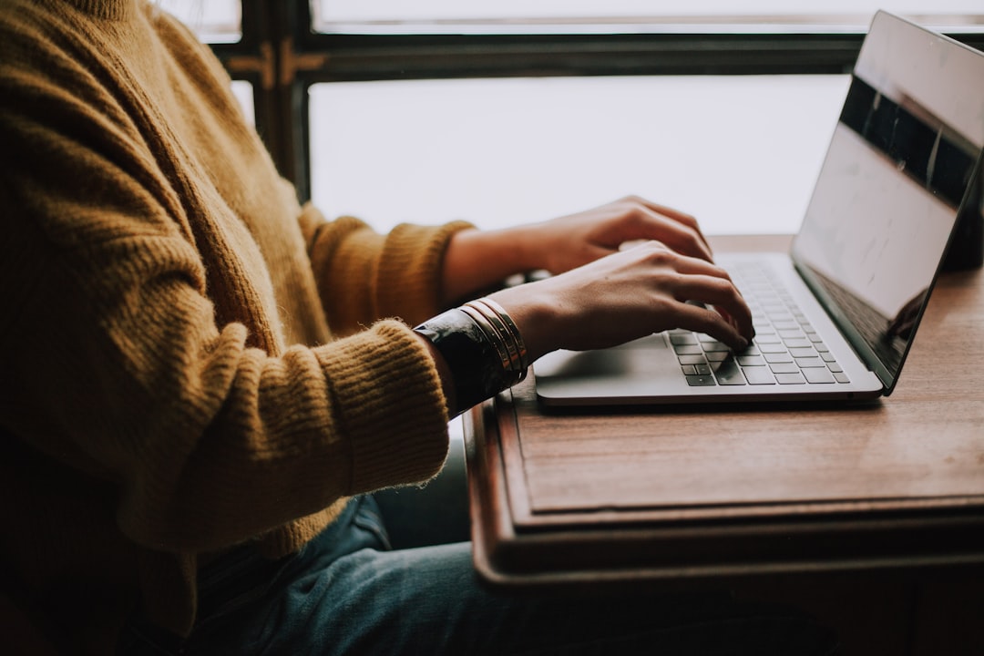 Professional typing on a laptop while developing content